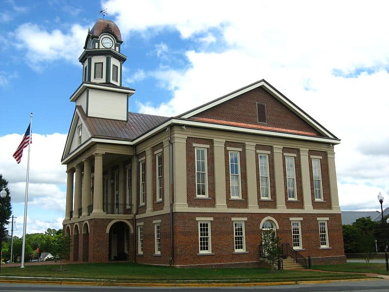 Historic Pittsboro Courthouse building with a clock tower and brick facade.
